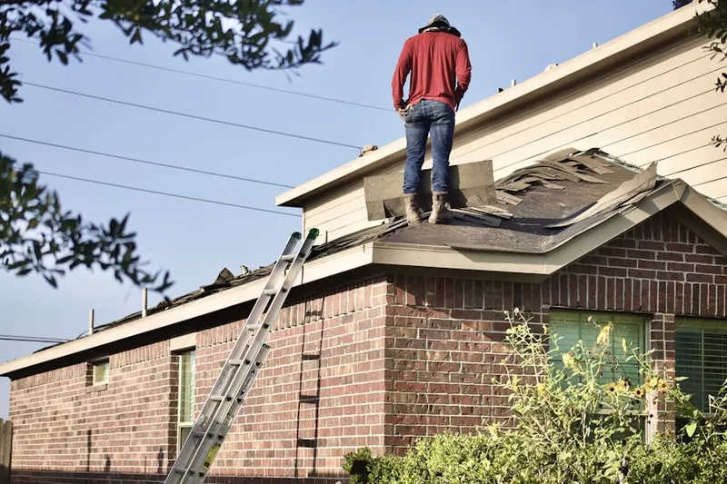 Professional roofer working on a residential roof in Poplar Pines